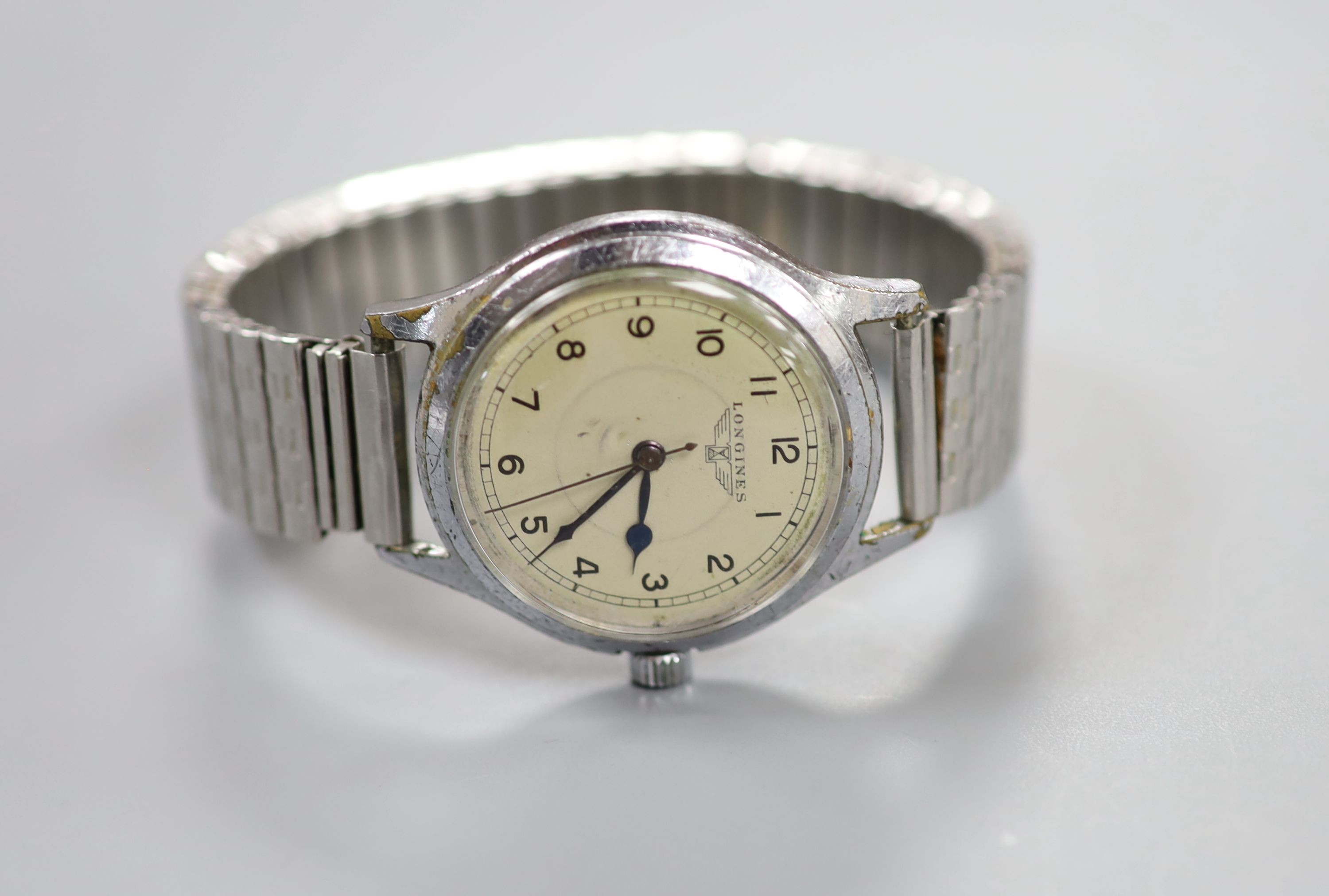 A gentleman's mid 20th century stainless steel Longines manual wind wrist watch, on associated flexible strap, case diameter 34mm.